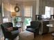 Cozy sitting area with comfortable chairs, a side table, and natural light streaming through the windows at 1205 Rivershyre Ne Pkwy, Lawrenceville, GA 30043