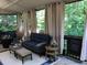 Inviting sunroom featuring comfortable seating, neutral curtains, and serene wooded views at 1205 Rivershyre Ne Pkwy, Lawrenceville, GA 30043