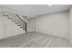 View of the basement featuring light gray flooring, storage cabinets, and a staircase with dark metal railings at 1887 Shalimar Dr, Atlanta, GA 30345