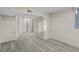 Finished basement room with gray floors, storage, and access to another room at 1887 Shalimar Dr, Atlanta, GA 30345