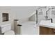 Modern bathroom featuring sleek white tile flooring and shower, complemented by a floating vanity and contemporary fixtures at 1887 Shalimar Dr, Atlanta, GA 30345