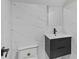 Modern bathroom featuring marble tiled walls, vanity with modern fixtures, and toilet at 1887 Shalimar Dr, Atlanta, GA 30345