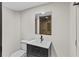 View of the bathroom featuring a dark vanity and sink, toilet, and shower with neutral-toned tile at 1887 Shalimar Dr, Atlanta, GA 30345