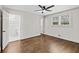 Inviting bedroom with hardwood floors, a ceiling fan, natural light, and an ensuite bathroom at 1887 Shalimar Dr, Atlanta, GA 30345