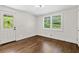 Bedroom featuring wood floors, natural light, and a door to the backyard at 1887 Shalimar Dr, Atlanta, GA 30345
