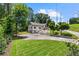 Expansive lawn highlights this lovely two-story home, featuring a balcony and mature trees, set back from the road at 1887 Shalimar Dr, Atlanta, GA 30345
