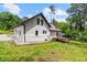 Side exterior view with a small deck, traditional windows and a well-manicured lawn at 1887 Shalimar Dr, Atlanta, GA 30345