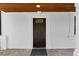 Elegant front door entrance featuring a dark wood door, stone tile porch, and pristine white columns and trim at 1887 Shalimar Dr, Atlanta, GA 30345