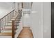 Bright hallway featuring wood floors, a staircase with modern railings, and neutral walls for a clean, contemporary look at 1887 Shalimar Dr, Atlanta, GA 30345