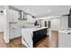 Modern kitchen with white cabinetry, striking black and white stone island, and stainless steel appliances at 1887 Shalimar Dr, Atlanta, GA 30345