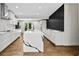 Modern kitchen featuring white cabinets, a large island with quartz countertops and stainless steel appliances at 1887 Shalimar Dr, Atlanta, GA 30345