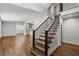 Open living room showcases gleaming hardwood floors, recessed lighting, a staircase, and a peek into the modern kitchen at 1887 Shalimar Dr, Atlanta, GA 30345