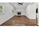 Open-concept living room with a fireplace, hardwood floors, a ceiling fan, and natural light at 1887 Shalimar Dr, Atlanta, GA 30345