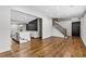 Spacious open-concept area showcases hardwood floors, an island kitchen, modern staircase, and access to a door at 1887 Shalimar Dr, Atlanta, GA 30345