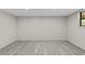 Spacious room featuring light gray flooring and freshly painted walls, with a large window for natural light at 1887 Shalimar Dr, Atlanta, GA 30345