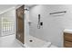 Modern glass shower with stone tile floor, marble tiled walls, and black fixtures offering a spa-like experience at 1887 Shalimar Dr, Atlanta, GA 30345