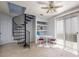 Cozy bonus room with unique spiral staircase, adjacent to sliding glass doors and built-in shelves at 2507 Albion Farm Way, Duluth, GA 30097