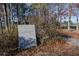 A stone memorial dedicated to DeKalb County veterans surrounded by trees at 2628 Amberly Dr, Dunwoody, GA 30360