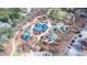 Community playground aerial view with varied play structures, shaded seating, and walkways amidst mature trees at 2628 Amberly Dr, Dunwoody, GA 30360