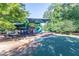 Playground featuring a green slide, covered play area, seating, and protective safety surfacing at 2628 Amberly Dr, Dunwoody, GA 30360