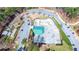Aerial image of a skate park near buildings, with concrete ramps, rails, and green shelter at 2628 Amberly Dr, Dunwoody, GA 30360