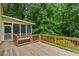 Spacious back deck with wood railings, perfect for enjoying the serene wooded surroundings at 3802 Sw Knights Bridge Sw Rd, Lilburn, GA 30047