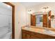 Vanity with double sinks and framed mirror plus tub with sliding glass doors at 3802 Sw Knights Bridge Sw Rd, Lilburn, GA 30047