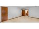 Neutral carpeted bedroom featuring a door to the bathroom for convenience at 3802 Sw Knights Bridge Sw Rd, Lilburn, GA 30047