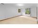 Bright bedroom with neutral carpet, white walls and a window with curtains at 3802 Sw Knights Bridge Sw Rd, Lilburn, GA 30047