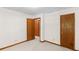 Bedroom featuring two wooden doors and neutral carpet at 3802 Sw Knights Bridge Sw Rd, Lilburn, GA 30047