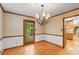 Charming dining room with hardwood floors, elegant chandelier, and wainscoting at 3802 Sw Knights Bridge Sw Rd, Lilburn, GA 30047