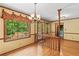 Sunny dining room featuring a large window, hardwood floors, and decorative chandelier at 3802 Sw Knights Bridge Sw Rd, Lilburn, GA 30047