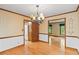 Classic dining room with hardwood floors, chandelier, and views to the kitchen at 3802 Sw Knights Bridge Sw Rd, Lilburn, GA 30047