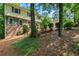 Two story home with a lush green lawn, mature trees, and brick accents at 3802 Sw Knights Bridge Sw Rd, Lilburn, GA 30047