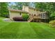 Two-story home with a lush green lawn, deck and screened porch; ideal for outdoor living at 3802 Sw Knights Bridge Sw Rd, Lilburn, GA 30047