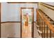 Inviting foyer showcasing a staircase and view into the kitchen with hardwood floors at 3802 Sw Knights Bridge Sw Rd, Lilburn, GA 30047