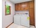 Functional laundry room with washer, dryer, and storage cabinets at 3802 Sw Knights Bridge Sw Rd, Lilburn, GA 30047