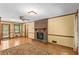 Bright living room featuring a brick fireplace, hardwood floors, and access to the deck at 3802 Sw Knights Bridge Sw Rd, Lilburn, GA 30047