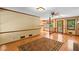 Open living room area with hardwood floors, access to the kitchen, and natural light at 3802 Sw Knights Bridge Sw Rd, Lilburn, GA 30047