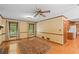 Bright living room featuring hardwood floors, brick fireplace, and large windows at 3802 Sw Knights Bridge Sw Rd, Lilburn, GA 30047