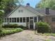 Bungalow style home featuring stone accents and a sunroom at 602 Hamilton Holmes Dr, Atlanta, GA 30318
