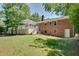 Large backyard with a deck, patio, and lush green lawn, ideal for outdoor entertaining and recreation at 1448 Diamond Head Cir, Decatur, GA 30033