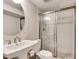 Bathroom featuring a pedestal sink and shower with white tiled walls and glass doors at 1448 Diamond Head Cir, Decatur, GA 30033