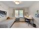 Bright bedroom featuring a single bed, study desk and chair, and natural light from the window at 1448 Diamond Head Cir, Decatur, GA 30033