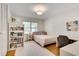 Bright bedroom with a desk, bookshelf, neutral decor, and natural light at 1448 Diamond Head Cir, Decatur, GA 30033