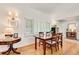 Dining area with a wood table, hardwood floors, plantation shutters, and decorative lighting at 1448 Diamond Head Cir, Decatur, GA 30033
