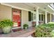 Welcoming front porch with a red front door, ample seating, and decorative plants at 1448 Diamond Head Cir, Decatur, GA 30033