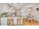 Modern kitchen features white cabinets, stainless steel appliances, and granite countertops with barstool seating at 1448 Diamond Head Cir, Decatur, GA 30033