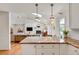 Well-lit kitchen featuring granite countertops, white cabinets, and open sight lines into the living space at 1448 Diamond Head Cir, Decatur, GA 30033