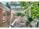 Outdoor patio with dining set under a pergola-covered deck, perfect for entertaining and relaxation at 1448 Diamond Head Cir, Decatur, GA 30033